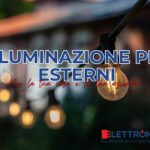 lampadina calda in un ambiente esterno come quello di un guardino. Sullo sfondo una abitazione in mattoni.